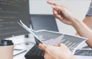 people in front of a computer analysing data and discussing cyber risk