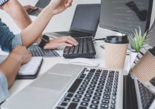 working on computers and laptops