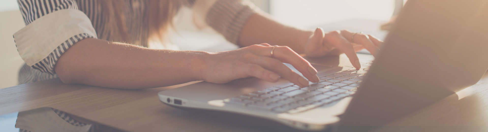 woman typing on a laptop
