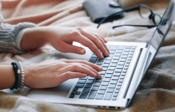 young bearded manager working and reading data on laptop in home office